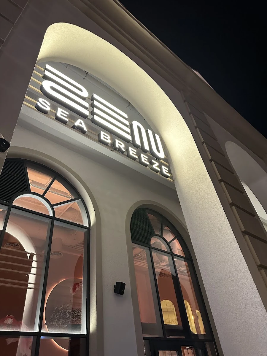 The ZEN facade in Marina Village: an illuminated sign above arched shop windows