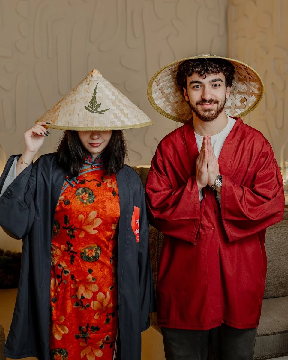 Guests in Asian costumes at the entrance to the restaurant