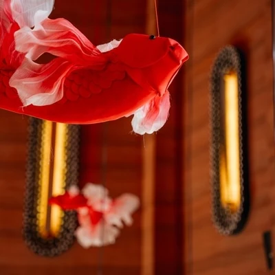 Red paper koi carp in an illuminated niche of the hall