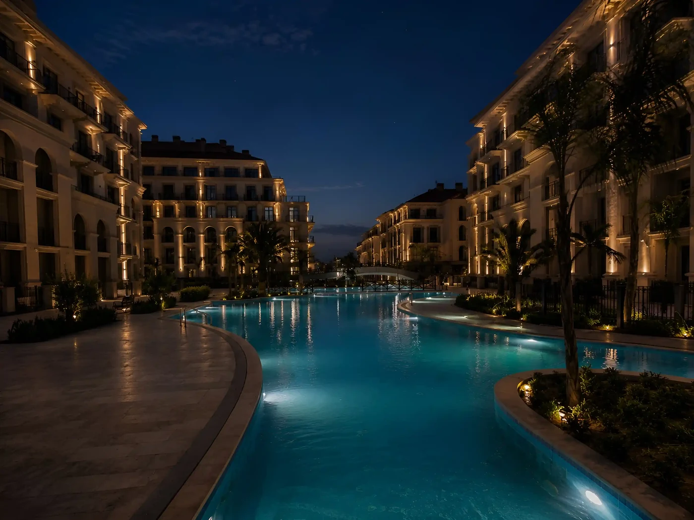 A canal-pool between the Marina Village buildings at night
