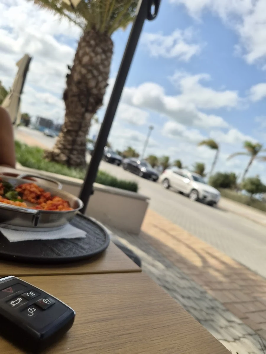 A table on the terrace overlooking the Marina Village passage